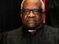 Associate Justice Clarence Thomas sits during a group photo of the Justices at the Supreme Court in Washington, DC in 2021