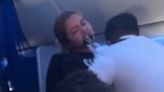 Shocking moment airline passenger bites flight attendant in mid-air meltdown