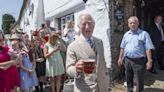 Charles enjoys local beer in sweltering Devon sunshine