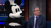 John Oliver Dares Disney to Sue as He Brings Steamboat Willie on Colbert: ‘I’m Legally Indestructible’ | Video