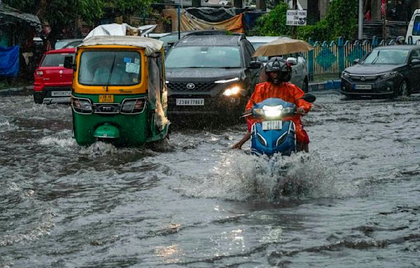 A tropical storm floods villages and cuts power to millions in parts of Bangladesh and India