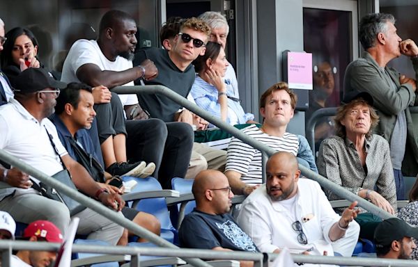 Swimming Rock Star Léon Marchand, Actual Rock Star Mick Jagger Take in Olympic Track