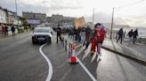 Residents stage costumed conga line protest over seaside town's bendy road lines