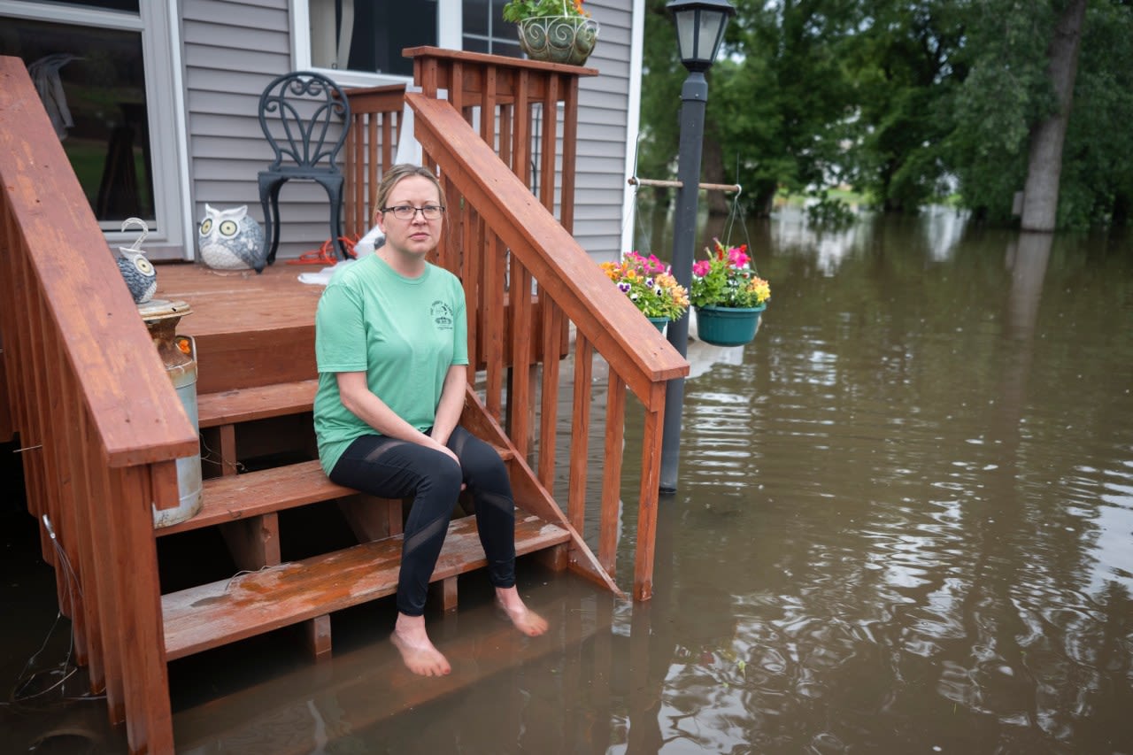 Swollen river claims house next to Minnesota dam as flooding and extreme weather grip the Midwest