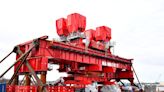 What is 110-foot tall red device that just arrived at Portsmouth Naval Shipyard?