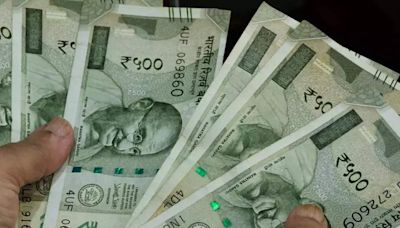 Rupee settles at record closing low as equity tax hikes hurt sentiment - ET BFSI