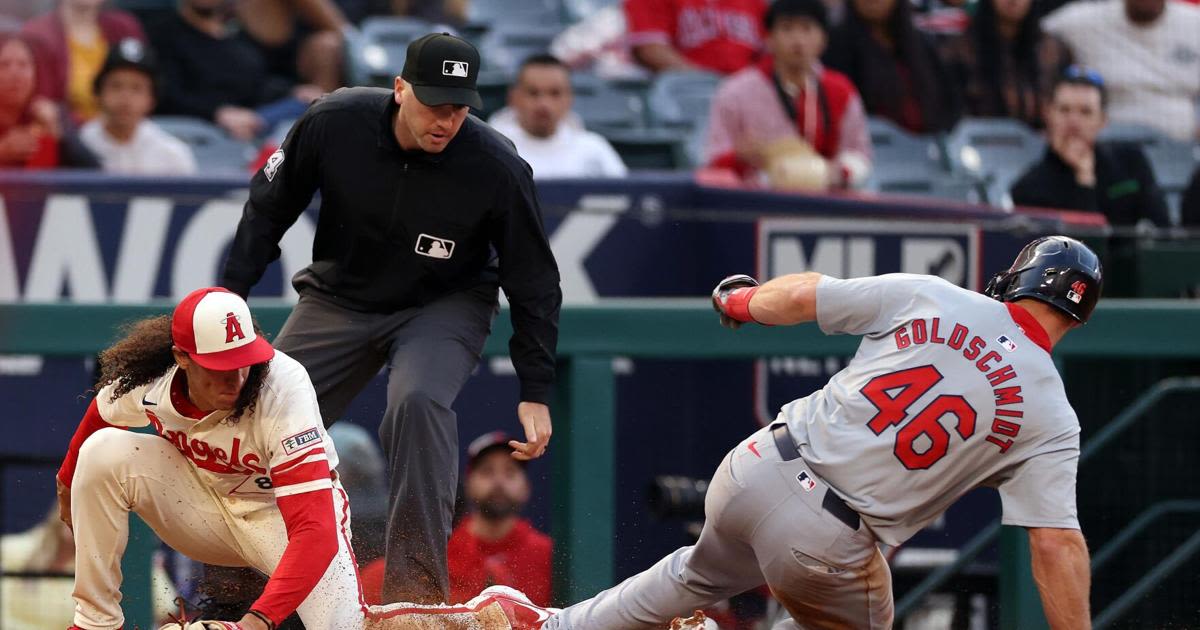 ...Paul Goldschmidt steals third base ahead of the throw to Los Angeles Angels' Cole Tucker, left, during the third inning at Angel Stadium of Anaheim on Tuesday, ...