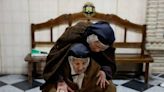 Visually impaired faithful explore Easter statues by fingertip in Ronda