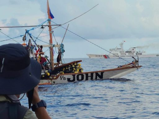 Filipino activists decide not to sail closer to disputed shoal, avoiding clash with Chinese ships