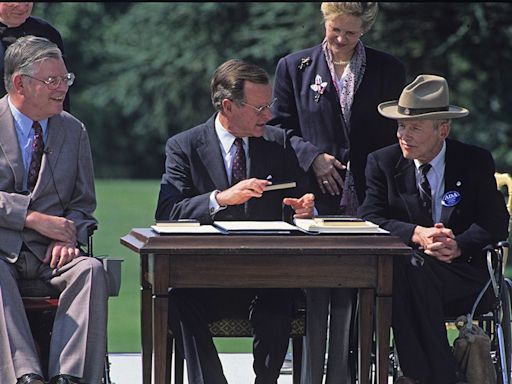 On this day in history, July 26, 1990, President George H.W. Bush signs Americans with Disabilities Act