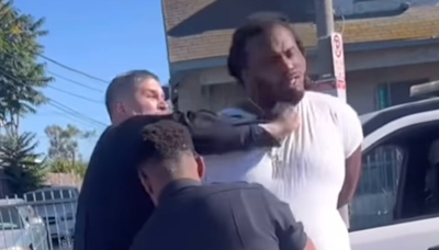 Shocking moment LAPD cop punches a man in the face while his hands are cuffed