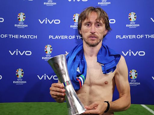 Luka Modric poses for the 'unhappiest Player of the Match Award ever'