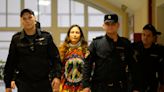 Russian artist jailed for staging anti-war supermarket protest as Putin pardons murderer of Kremlin-critic