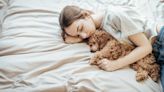 Sleeping with your dog in your bed is divisive—What do the experts say?