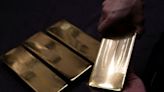 Gold slips to over one-week low on hawkish Fed, US data