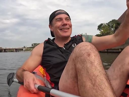 Man commutes to work kayaking on the river