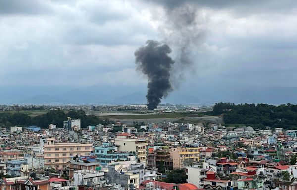 A plane slips off the runway and crashes in Nepal, killing 18 people and injuring a pilot