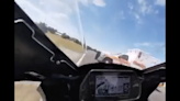 Watch a Motorcycle Racer Barely Miss an Ambulance Crossing a Hot Track