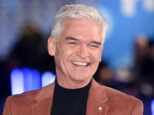 Smiley Phillip Schofield spotted with wife and daughters as they arrive at Grand Prix in style