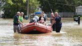 Firefighters help people from flooded homes along Plum Creek