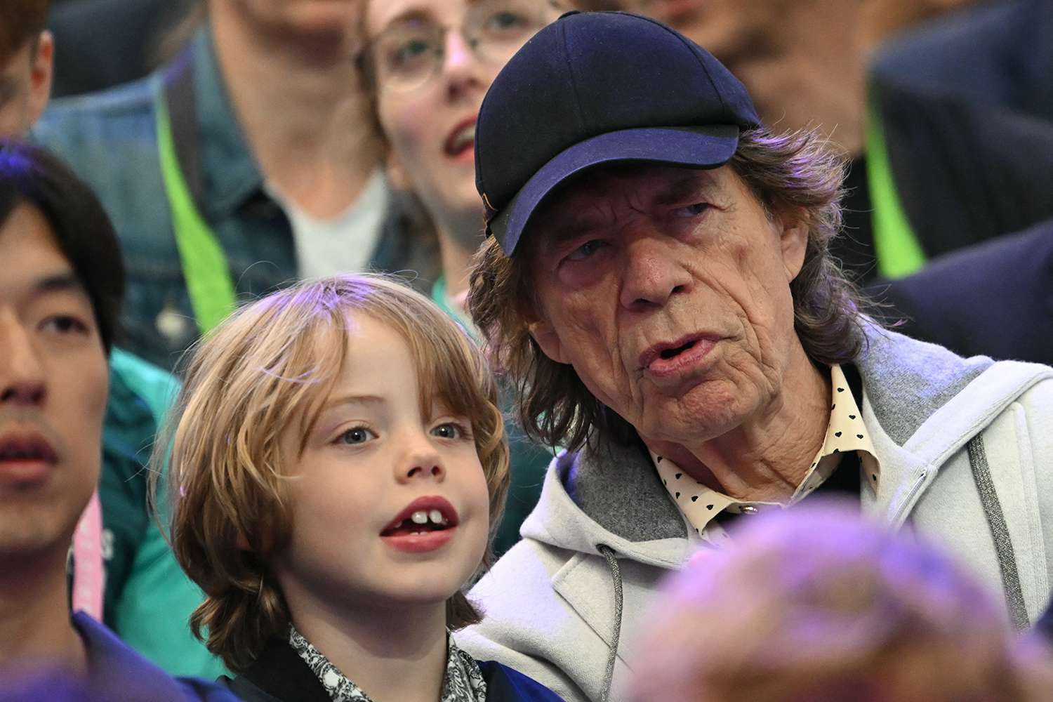 Mick Jagger and Son Deveraux, 7, Smile in the Stands as They Watch Fencing at the Paris Summer Olympics