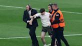 Champions League final interrupted by pitch invaders after less than a minute