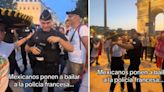 Aficionada mexicana se viraliza al convencer a policía francés de bailar con ella frente al arco del triunfo en París