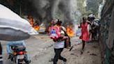 Former rebel leader arrives in Haiti's capital as protests against prime minister gain momentum