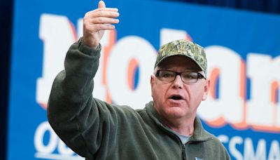 Tim Walz Looks the Everyman Part in Flannel Shirts and Camo Hats