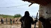 Afghans shovel mud from a house following flash floods after heavy rainfall at a village in Baghlan province, where hundreds of people have been killed in the disaster