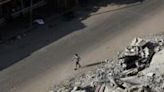 A Palestinian man walks past the rubble of buildings destroyed in Israeli bombardments, in Rafah, in the southern Gaza Strip, on April 30, 2024