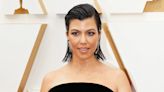 Kourtney Kardashian Shows Off Bare Baby Bump in Bold Blue Cropped Jacket, Responds to Critics
