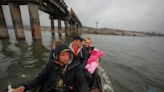 Rowing past their severed road bridge, Ukrainians return to liberated villages