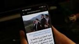 An Iranian checks a local news website on his smartphone in Tehran in search for the latest information on the search