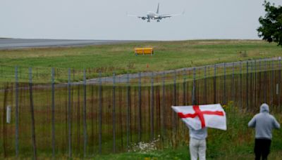 Southgate leads dejected England team off plane after landing in UK