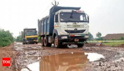 Back-breaking ride: Road filled with craters, trucks making them worse | Ghaziabad News - Times of India