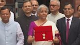 Finance Minister Poses With Tablet In Red Sleeve Ahead Of Budget Speech