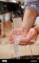 HANDFUL OF WATER FROM WATER FOUNTAIN Stock Photo - Alamy