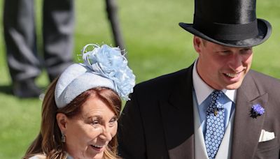 William helps Kate's mother as she gets her heel stuck in Ascot turf