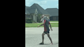 Man with alligator over his shoulder seen walking around Louisiana town, video shows
