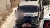 Israeli forces strap injured Palestinian to jeep bonnet and drive off