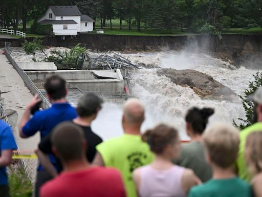 Part of a Minnesota home has plunged into a river as deadly flooding threatens the nearby Rapidan Dam