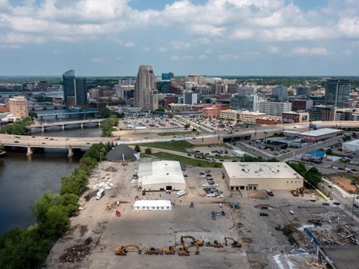 Drone video shows riverfront amphitheater construction site with Grand Rapids skyline