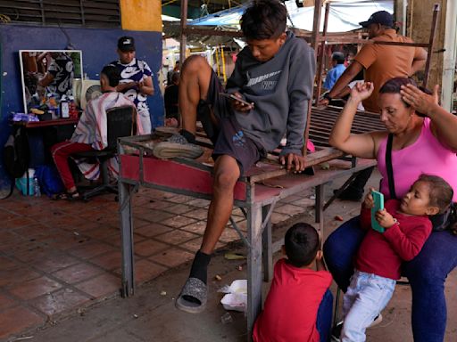 Venezuelans turn to odd jobs and gambling to stretch meager wages they hope will grow after election