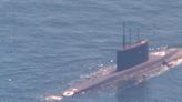 A NATO sub hunter captured these shots of a Russian submarine in waters newly surrounded by the alliance