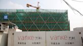 China Vanke shares, bonds fall after rating cut and government probe