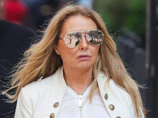 Carol Vorderman shows off her figure in tight green trousers