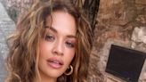 Rita Ora shows she poses in a tiny bikini while on a trip to Italy