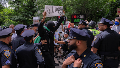 Masked protester hoists ‘Kill Hostages Now’ sign during Israel Day parade in NYC