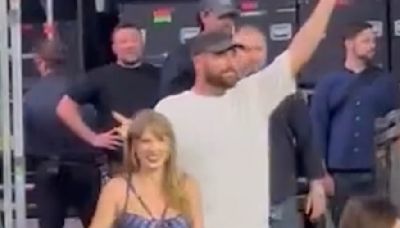 Travis Kelce and Taylor Swift hold hands as they leave Eras Tour stage